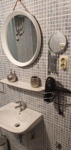 a bathroom with a sink and a mirror on a wall at B&B Palace Basilico 1580. in Rovinj +31 photos