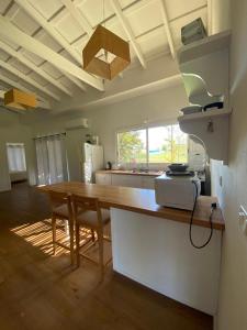 a kitchen with a wooden table and a counter top at Casa en Carmelo Golf Club in Carmelo
