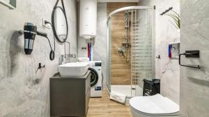a bathroom with a sink and a toilet and a shower at STEGNA PARK C Apartamenty Piamola WiFi in Stegna +194 photos