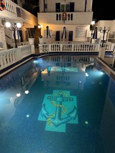 a large swimming pool with a anchor in the water at Hotel Porto Perissa in Perissa