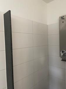 a bathroom with a shower with white tiles at Marina Lauenburg in Lauenburg +36 photos