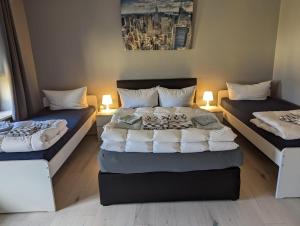 a bedroom with two beds and two lamps in it at Flensburg Zentrum 69 02 in Flensburg