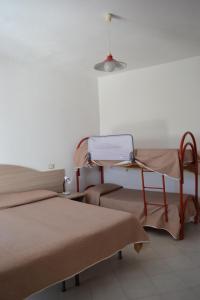 a hospital room with two beds and a table at Cocos Park Ischia in Ischia
