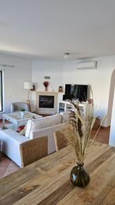 a living room with a couch and a table at Beachfront house,Manta Rota,Algarve in Vila Nova de Cacela