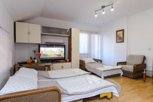 a room with two beds and a flat screen tv at The Cosmic Gate Apartments in Visoko