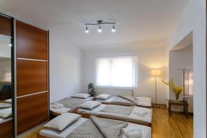 a room with four beds in it with a window at The Cosmic Gate Apartments in Visoko