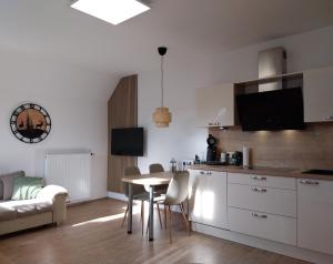 a kitchen and living room with a table and a couch at Ferienwohnung Naturpark Schwarzwald in Löffingen
