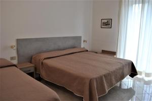 a bedroom with two beds in a room at Cocos Park Ischia in Ischia