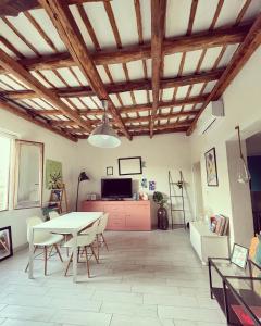 a living room with a table and chairs at Duende in Trapani