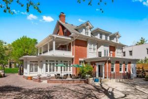 a large red brick house with white trim at Volker at Oak Street Mansion in Kansas City