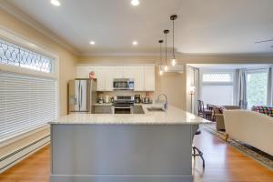 a kitchen with a large island in a room at Updated Sheboygan Home with Porch Less Than 1 Mi to Beach in Sheboygan