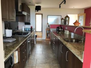 a kitchen with a sink and a counter top at An teach Illanmore in Portsalon