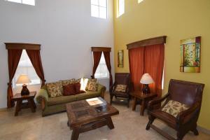 a living room with a couch and a table and chairs at San Felipe Ultra Deluxe Elegance with Spectacular Sea Views in Playa El Paraíso