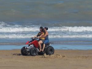 three people riding a quad bike on the beach at Spectacular 3BR 3BA San Felipe Villa with WiFi FREE GOLF in Playa El Paraíso