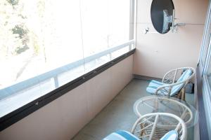 a room with two chairs and a window at HH Huoneistot Suite in Forssa