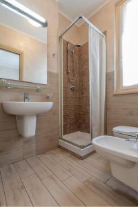 a bathroom with a shower and a sink and a toilet at Affittacamere Borgo Roma in Verona