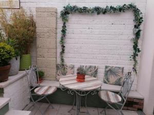 a table and chairs on a patio with a wreath at No 12 B&B in Dungarvan