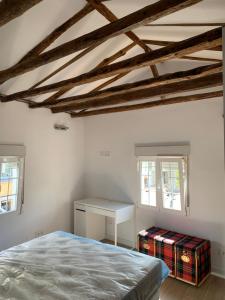 a bedroom with a bed and a desk at Casa Moralzarzal jardin Sierra Madrid in Moralzarzal