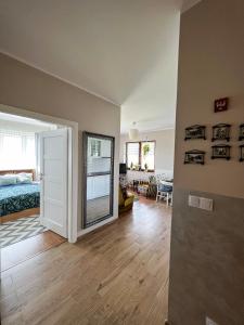 a bedroom with a bed and a living room at Apartament Zdrojowy 62 K in Nałęczów