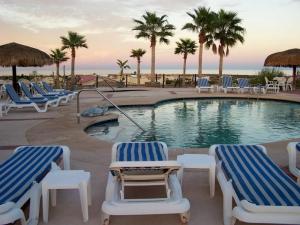 a swimming pool with lounge chairs and palm trees at Casa Melissa - 3 Bedroom Playa de Oro San Felipe rental home in San Felipe