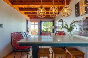 a dining room with a blue table and red chairs at The Red Door Mountain Cabin in Guadalupe
