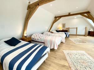 a room with three beds in a attic at Le Familik- Maison- CentreVille in Licques