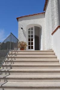 a set of stairs leading to a white building at Cocos Park Ischia in Ischia