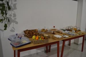 a table with many baskets of food on it at Cocos Park Ischia in Ischia