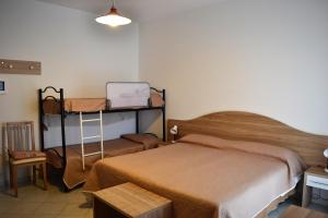 a bedroom with two bunk beds and a table at Cocos Park Ischia in Ischia