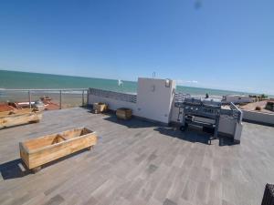 a patio with a grill on a roof with the ocean at La Hacienda San Felipe Mexico Vacation Rental in San Felipe