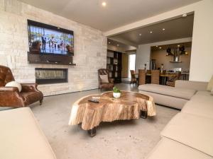 a living room with a wooden coffee table and a fireplace at La Hacienda San Felipe Mexico Vacation Rental in San Felipe