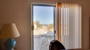 a sliding glass door leading to a patio with a table at El Dorado Ranch Rental - Judy`s Casita in San Felipe