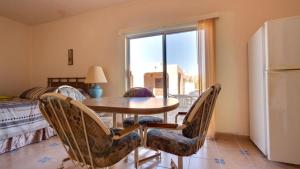 a dining room with a table and chairs and a window at El Dorado Ranch Rental - Judy`s Casita in San Felipe