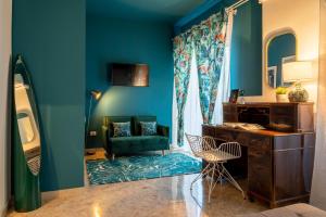 a blue room with a desk and a chair at Libertà #102 - Guest House Palermo in Palermo