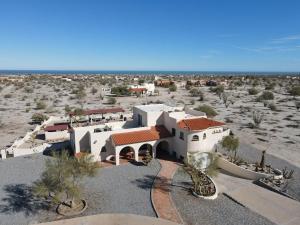 a large white building in the middle of the desert at El Dorado Ranch San Felipe - Casa Rocky Point Vacation Rental with Private Pool in San Felipe