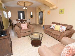 a living room with couches and a table at Casa PortoBello - Intown home in San Felipe