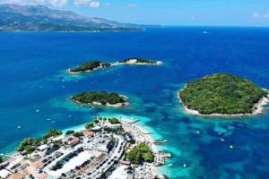 an aerial view of a group of islands in the water at Hotel Four Islands in Ksamil