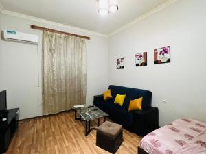 a living room with a couch and a bed at Apartment on Bagratuniats Street in Yerevan