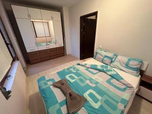 a small bedroom with a bed and a mirror at Vqra Sarafovo in Burgas