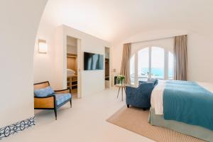 a hotel room with a bed and a window at Palazzo M Capri in Capri