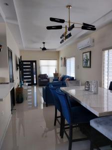 a living room with a table and blue chairs at PYRAMID JOY, 2 Bedroom Villa, Ocho Rios, Jamaica in Ocho Rios
