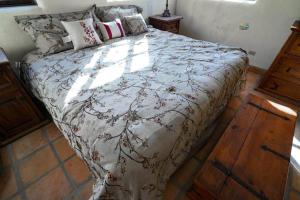 a bedroom with a large bed with a floral comforter at Casa Chaparral - Beautiful vacation home for rent in San Felipe in San Felipe