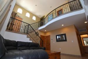 a living room with a couch and a staircase at 3-bedroom Poolside San Felipe Vacation villa in La Ponderosa