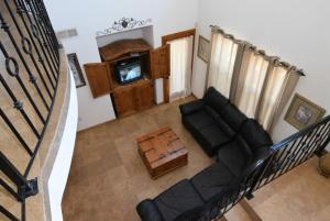 an overhead view of a living room with a couch and a tv at 3-bedroom Poolside San Felipe Vacation villa in La Ponderosa