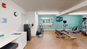 a room with a gym with exercise equipment in it at Holiday Inn Express South Burlington, an IHG Hotel in Burlington