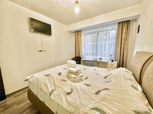 a bedroom with a bed and a window at Green terrace in Brasov in Braşov