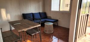 a living room with a blue couch and a table at Cabañas San José Chotuj 