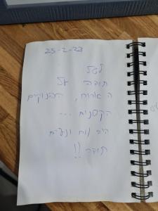 a notebook with the equations on top of it next to acomputer at Yvonne Hostel Sde Boker in Midreshet Ben Gurion +1 photo