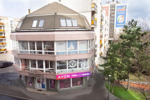 a building with a sign on the front of it at Zsófia Apartman in Veszprém