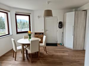 a dining room with a table and chairs at Green Apartment Cerknica in Cerknica